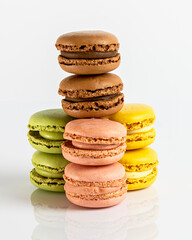 Close up multicolored macarons lined up on a white background. Typical french sweet