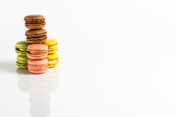 Multicolored macarons lined up on a white background. Typical french sweet