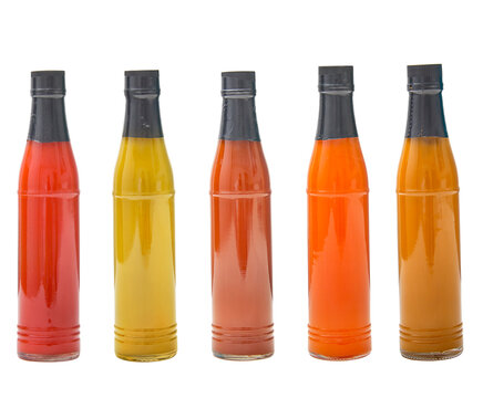 Set of glass bottles with  delicious sauces on white background