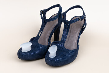 Feet silicone toe separator on high-heeled shoe. Valgus disease concept on female feet