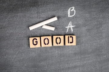 Good and Bad concept. Wooden alphabet letters on a gray chalk board