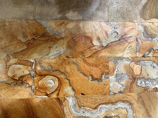 Moss growing and white flowers on the walls of a temple in Bali