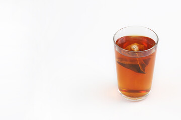 Fototapeta na wymiar A glass of tea with tea bag isolated on white background.