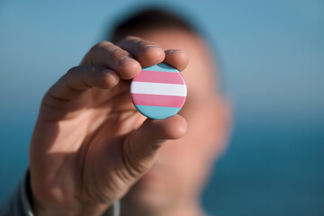 person shows a transgender pride flag
