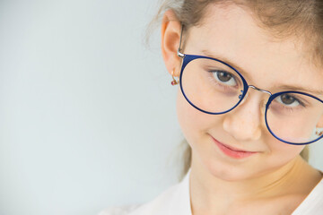 portrait of a cute and beautiful 8 year old girl with glasses