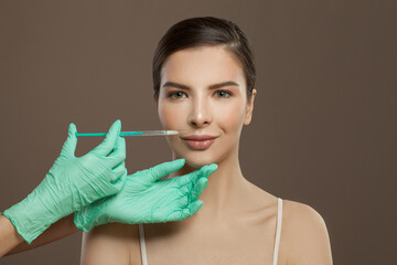 Lip augmentation concept. Perfect woman face and syringe injection