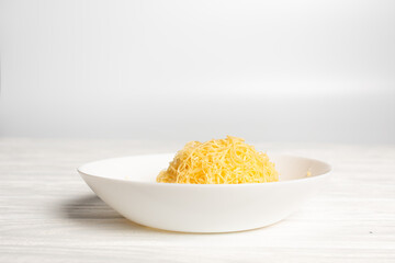 fresh grated cheese. Grater and cheese on board