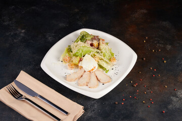 Fresh caesar salad on plate with parmesan cheese