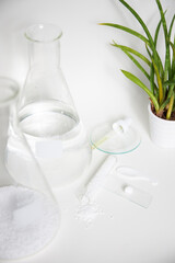 Abstract cosmetic or chemical laboratory. Preparation of a cosmetic product. Transparent chemical flasks on a white background.