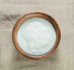 cream sour in big wooden bowl on a canvas