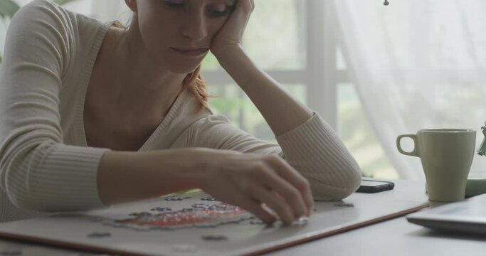 Bored woman composing a puzzle
