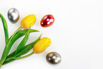 colorful decorative easter eggs and flowers yellow tulips