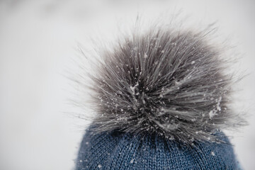 Close up of pompom on the child's head, all in snowflakes