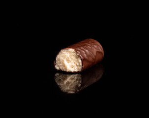 ?andy with coconut filling in chocolate isolated on dark background