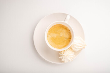 Coffee and airy French dessert isolated on white background.