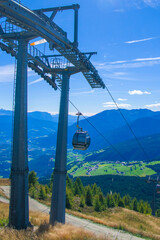 cable car takes tourists to the high mountains under the summer sun