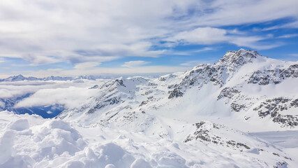 Fototapeta na wymiar Beautiful and serene landscape of mountains covered with snow in Moelltaler Gletscher, Austria. Thick snow covers the slopes. Clear weather. Perfectly groomed slopes. Massive ski resort.