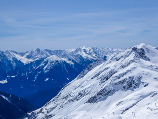 Beautiful and serene landscape of mountains covered with snow in Moelltaler Gletscher, Austria. Thick snow covers the slopes. Clear weather. Perfectly groomed slopes. Massive ski resort.