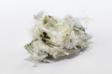 Chrysotile asbestos fibers lie in a heap on white background Macro photography.
