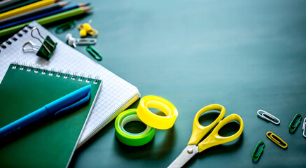 Business training or student lectures. Notebook pen pencils on the table, chalk and chalk board. Flat layout with copy space. School and office supplies concilary goods.