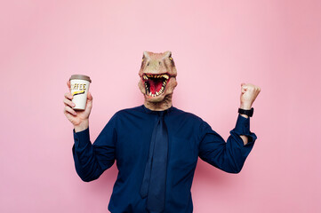 Man with dinosaur head holding a cup of coffee