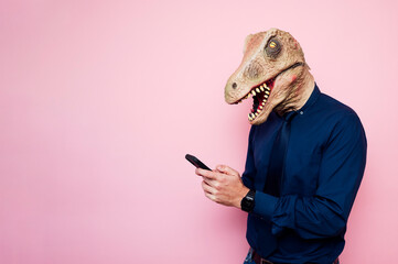 man in dinosaur mask using smartphone