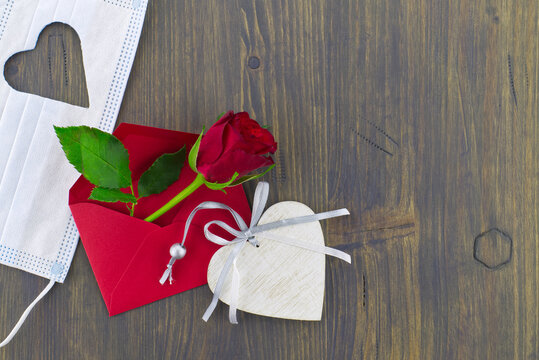 Medical mask heart shape and red rose in envelope