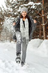 Girl Walking On The Snow With Boots, Young woman kicks snow with her foot on winter road in forest