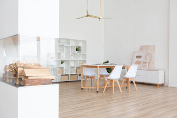 interior design spacious bright studio apartment in Scandinavian style and warm pastel white and beige colors. trendy furniture in the living area and modern details in the kitchen area.