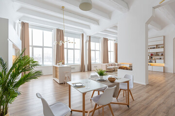 interior design spacious bright studio apartment in Scandinavian style and warm pastel white and beige colors. trendy furniture in the living area and modern details in the kitchen area.