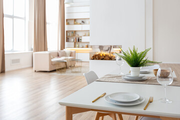 interior design spacious bright studio apartment in Scandinavian style and warm pastel white and beige colors. trendy furniture in the living area and modern details in the kitchen area.