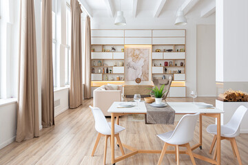 interior design spacious bright studio apartment in Scandinavian style and warm pastel white and beige colors. trendy furniture in the living area and modern details in the kitchen area.