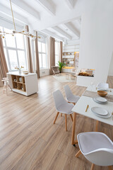 interior design spacious bright studio apartment in Scandinavian style and warm pastel white and beige colors. trendy furniture in the living area and modern details in the kitchen area.