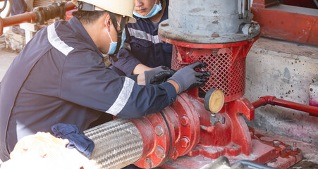 maintenance man check height temperature of motor fire pump in the factory