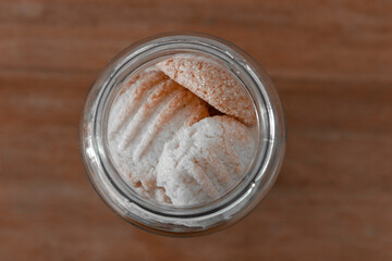 glass Jar with homemade cookies on light background