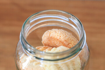 glass Jar with homemade cookies on light background