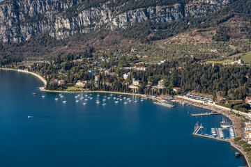 Naklejka premium Aerial View of the Small Garda Town, tourist resort on the coast of Lake Garda, view from the Rocca di Garda, small hill overlooking the lake. Verona province, Veneto, Italy, Europe.