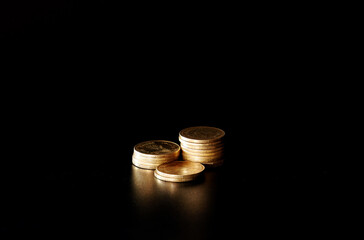stacks of gold coin on black background concept saving money