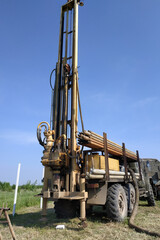 Machine for drilling wells for water, drilling a well in the garden, the drilling process close up.