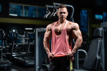 Naklejka premium young sportsman bodybuilder with muscle body have workout in gym