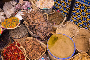 Colorful spices baskets in a street of Meknes, Morocco.