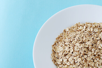 raw oat grains in a white plate