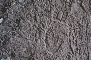 Sand on beach, many footprints in sand, textured surface, horizontal photography, natural material, outdoors close-up