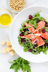 Flat lay crab salad, with pine nuts, beets, herbs, olive oil and hard cheese
