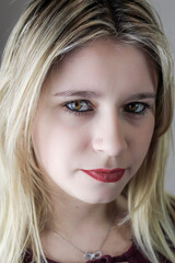 Close up portrait of a beautiful young woman with blonde hair and red lipstick