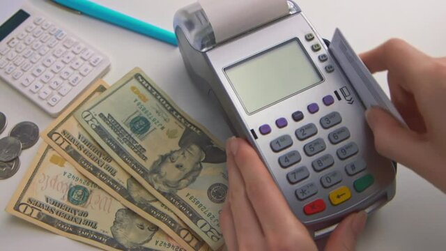 A woman's hand swipes a card into a debit machine. The screen says "APPROVED". Check out this seller's other videos for "DECLINED" transactions. (Camera Used: Canon C300)