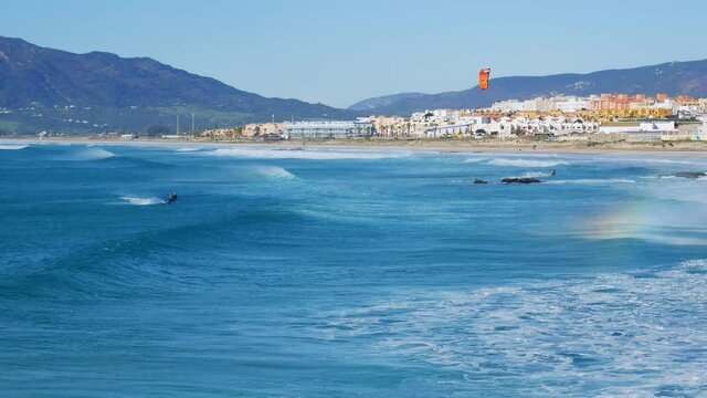 Tarifa, Spain - 24 december 2019: The kite-surfing surfer sails on the ocean wave. Spain. Tarifa.