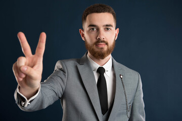 Young businessman showing peace sign