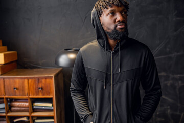 Fototapeta na wymiar portrait of a young African-American man in sportswear in a hood