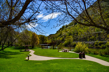 Fototapeta na wymiar Table and benches in a recreation area near a small river in Utah, US